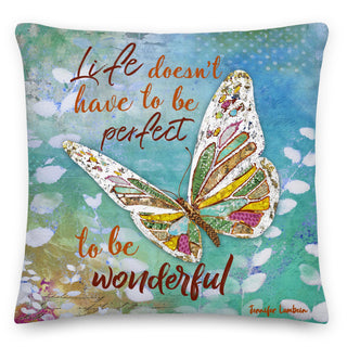 A throw pillow with a whimsical butterfly on a colorful sky background that says, "Life doesn't have to be perfect to be wonderful." 