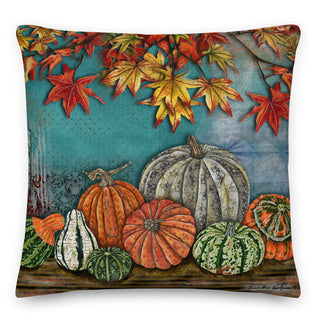 A throw pillow with a watercolor nature scene of pumpkins, gourds and fall leaves. Artwork by Jennifer Lambein. 