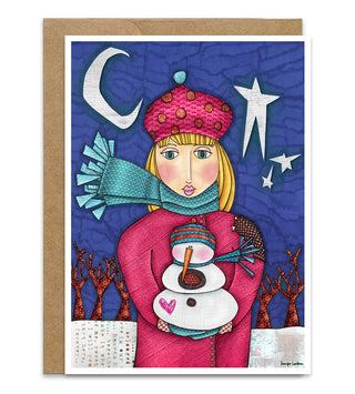 A greeting card with a whimsical folk art winter Christmas girl in pink holing a snowman standing in front of bare trees a white moon and stars. Artwork by Jennifer Lambein. 