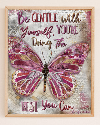 Framed artwork with a pink butterfly and motivational quote on a textured background