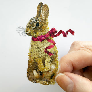 A cute boho cottagecore bunny rabbit sticker with a pink Easter ribbon. 