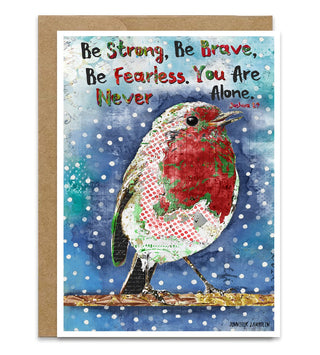 A Christmas greeting card featuring a collage-style robin bird perched on a branch against a snowy blue background, with the tChristian bible verse, 'Be Strong, Be Brave, Be Fearless. You Are Never Alone. Joshua 1:9. Artwork by Jennifer Lambein. 