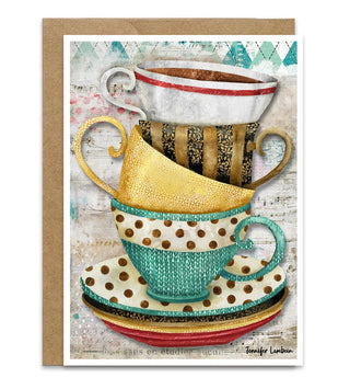 A greeting card featuring a stacked illustration of teacups and saucers in teal, gold, white, and brown, with a kraft paper envelope behind it on a white background. artwork by Jennifer Lambein. 