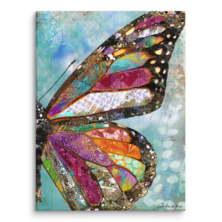 A canvas print with a whimsical butterfly wing on a blue sky background. Artwork by Jennifer Lambein. 