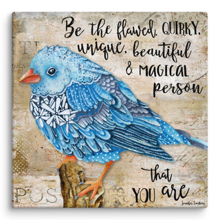 A canvas art print with a watercolor blue bird with wildflowers on a rustic taupe background that say, " Be the flawed, quirky, unique, beautiful and magical person that you are." Artwork by Jennifer Lambein. 
