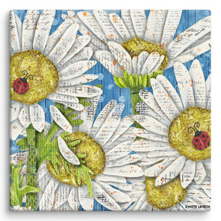 A canvas print with colorful daisies and ladybugs on a blue sky background. Artwork by Jennifer Lambein. 