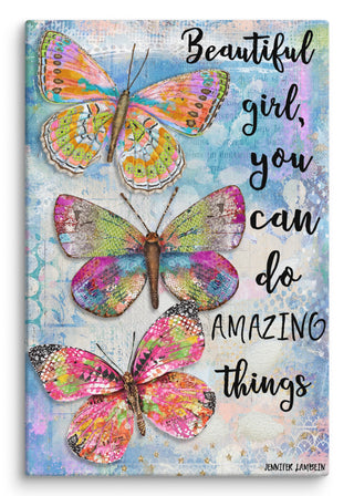 A canvas print with three bright butterflies on a blue background that says, "Beautiful girl, you can do amazing things." 