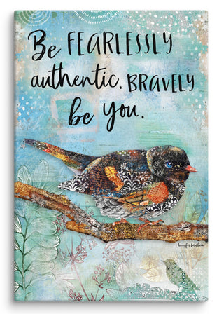 A canvas print with a whimsical bird on a blue sky background that says, "Be fearlessly authentic, bravely be you."