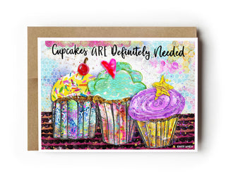 Card with colorful cupcakes and text 'Cupcakes ARE Definitely Needed' on a white background