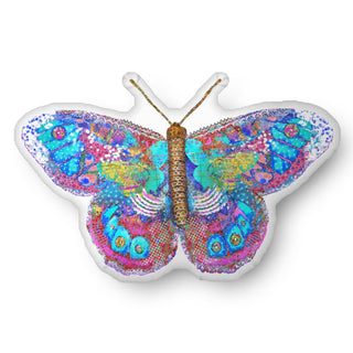 A throw pillow shaped like a whimsical blue and pink butterfly. Artwork by Jennifer Lambein. 