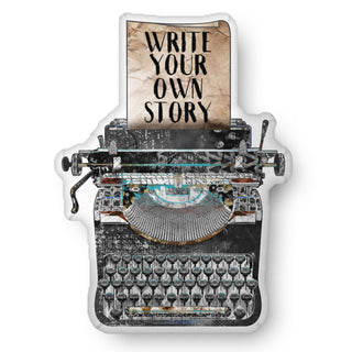 A custom shaped throw pillow in the shape of a vintage typewriter that says, " Write your own story." Artwrok by Jennifer Lambein. 