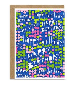 A square birthday card with a kraft paper envelope, featuring a blue background covered in pink and green dots, with the words 'happy birthday!' repeated in white script. Artwork by Jennifer Lambein. 