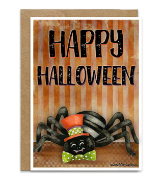 A Halloween greeting card with a kraft envelope, featuring the words 'HAPPY HALLOWEEN' in black distressed lettering above a smiling black spider wearing a red and green hat and bow tie, set against orange striped background art. Artwork by Jennifer Lambein.