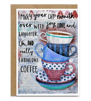 A greeting card with a kraft envelope, featuring a colorful illustration of stacked coffee cups and a printed quote that reads, 'May your cup runneth over with joy, love and laughter. Oh, and really fabulous coffee. Artwork by Jennifer Lambein. 