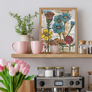 Decorative shelf with mugs, a plant, and a framed floral artwork on a light gray wall.
