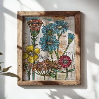 Framed artwork with colorful flowers on a white wall
