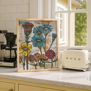 Framed floral artwork on a kitchen counter with a Smeg toaster.