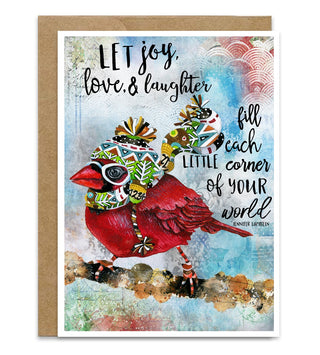A square greeting card with a brown kraft envelope, featuring a colorful watercolor-style red cardinal wearing a patterned knit hat and scarf, with the quote 'LET joy, love & laughter fill each little corner of YOUR world' by Jennifer Lambein.