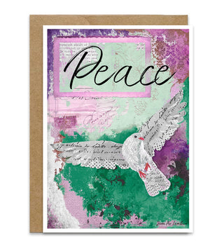 A  greeting card featuring a peace dove in white lace over a textured collage of green, pink, purple, and teal tones, with the word 'Peace' in black script. A kraft paper envelope is placed behind it on a white background. Artwork by Jennifer Lambein. 