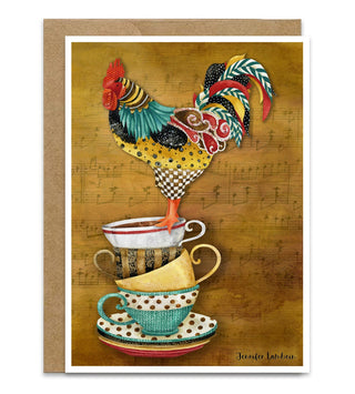 A greeting card featuring a colorful watercolor rooster perched on stacked teacups, with a brown kraft envelope behind it on a white background. Artwork by Jennifer Lambein.