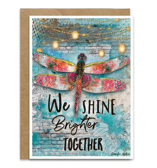 Greeting card with a dragonfly illustration and motivational quote on a decorative background.