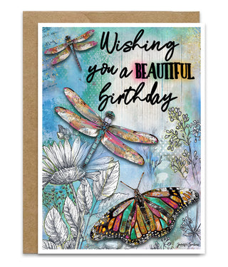 Birthday card with dragonflies, butterflies, and flowers on a blue background